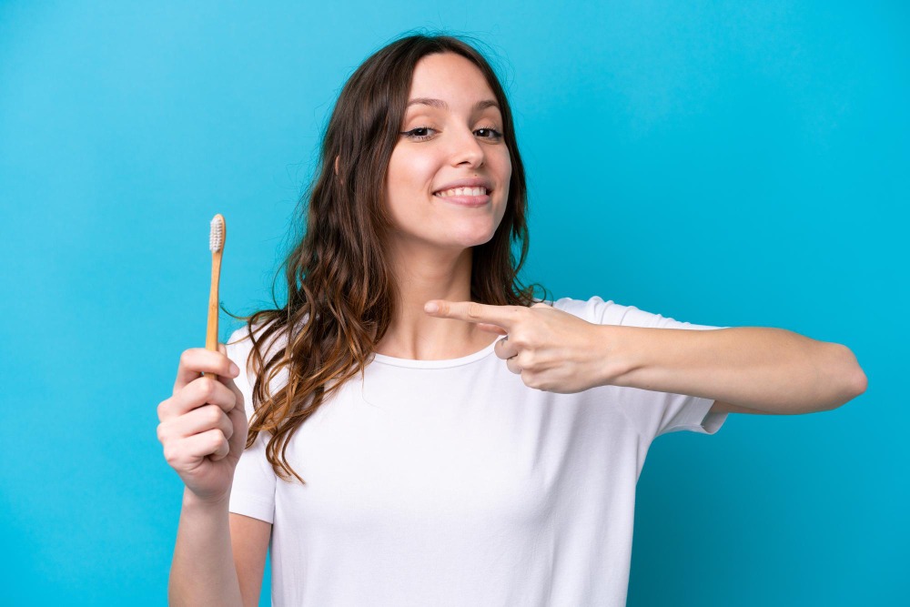 Dental Bridges in Ilford, Essex 3 woman holding tooth brush proper dental hygiene